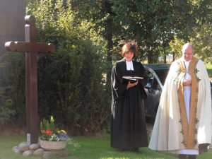 Pfarrerin Ingeborg Dahl und Pfarrer Hermann Josef Zeyen segnen das Kreuz 